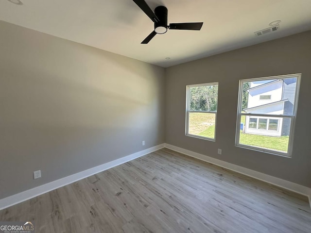 empty room with light hardwood / wood-style floors and ceiling fan