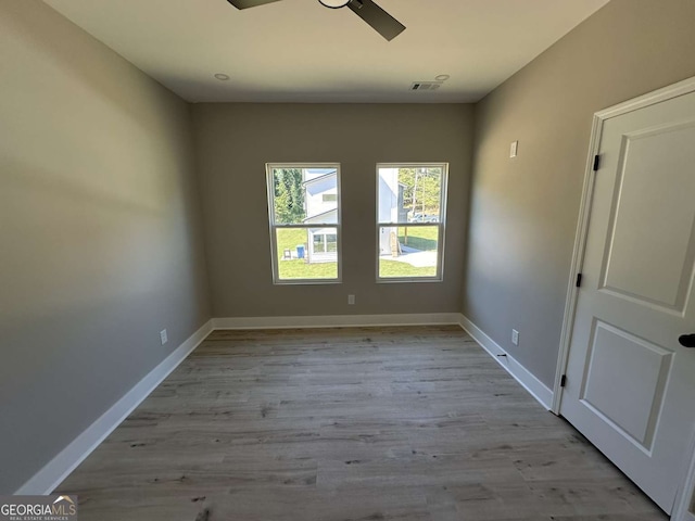 unfurnished room with light wood-type flooring and ceiling fan