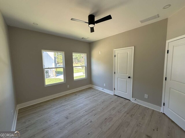 unfurnished bedroom with light wood-type flooring and ceiling fan