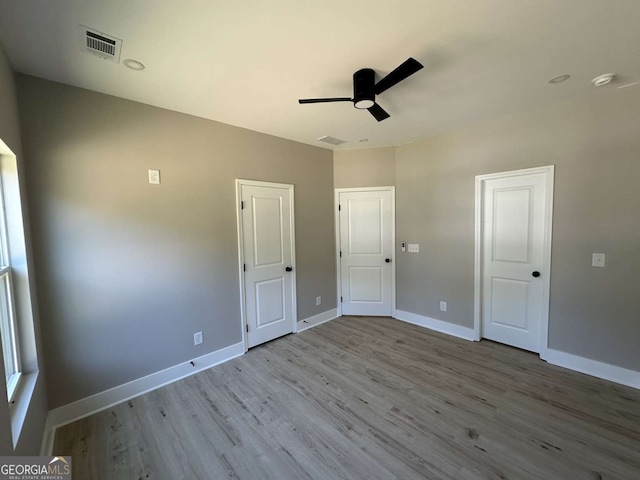 unfurnished bedroom with light hardwood / wood-style floors and ceiling fan