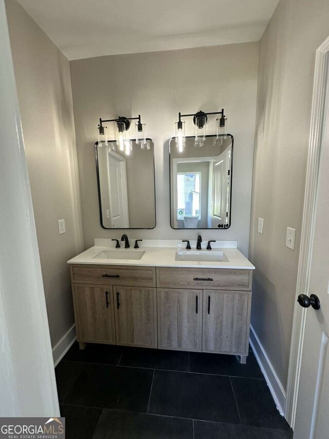 bathroom with tile patterned flooring and vanity