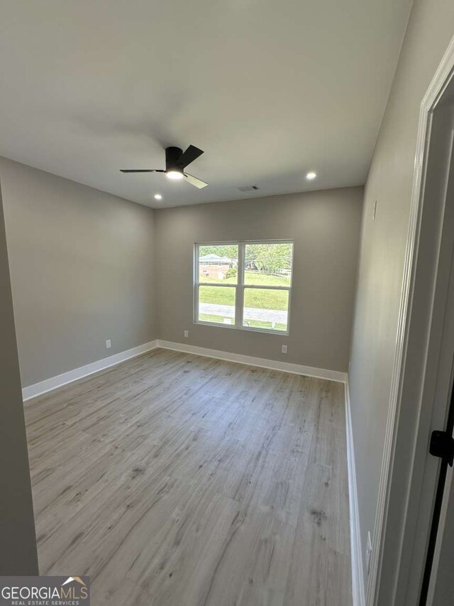 spare room with ceiling fan and light hardwood / wood-style floors