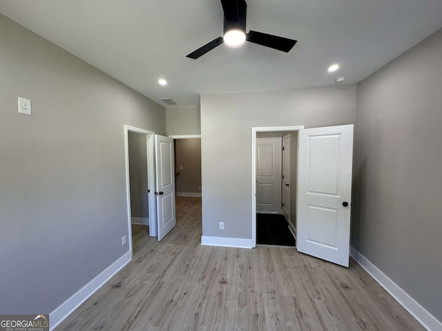 unfurnished bedroom featuring light wood-type flooring and ceiling fan