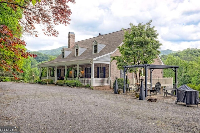 exterior space with a mountain view and a pergola