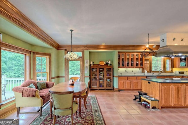 dining area featuring light tile patterned floors, sink, and ornamental molding