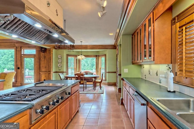 kitchen featuring ornamental molding, light tile patterned floors, decorative light fixtures, stainless steel appliances, and a chandelier