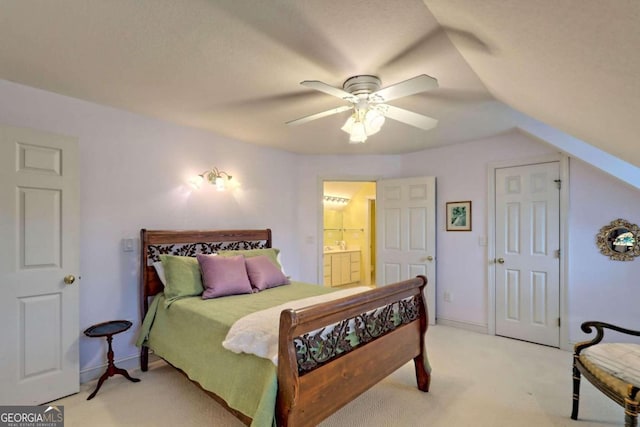 carpeted bedroom featuring ceiling fan, lofted ceiling, and connected bathroom