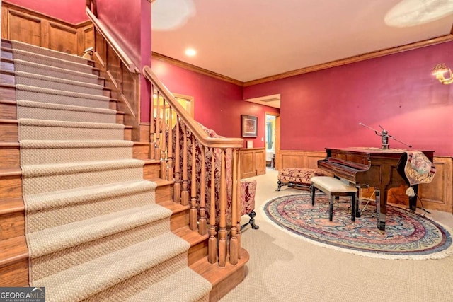 stairway with carpet and crown molding