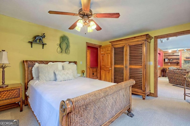 bedroom with ceiling fan and light carpet