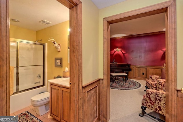 full bathroom with tile patterned floors, vanity, toilet, and shower / bath combination with glass door