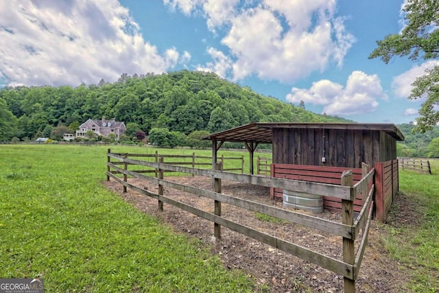 view of yard featuring an outbuilding and a rural view