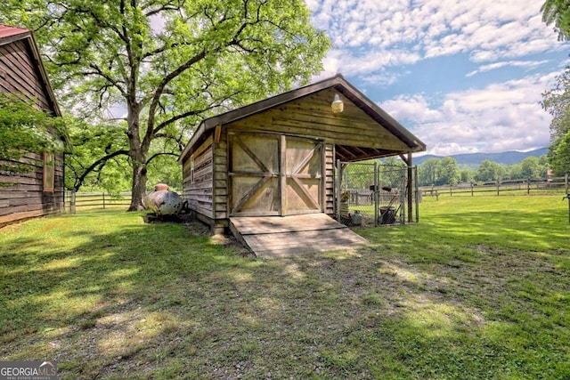 view of outbuilding with a mountain view and a rural view