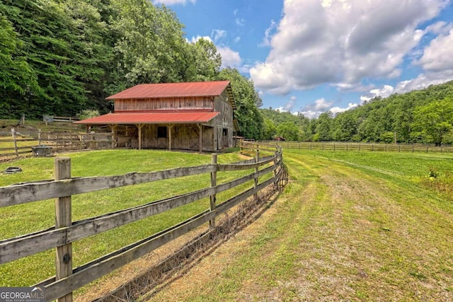 view of yard featuring a rural view and an outdoor structure