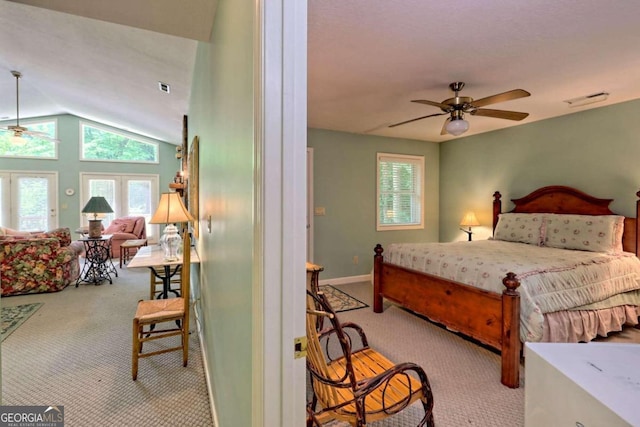 bedroom with ceiling fan, vaulted ceiling, light colored carpet, and french doors