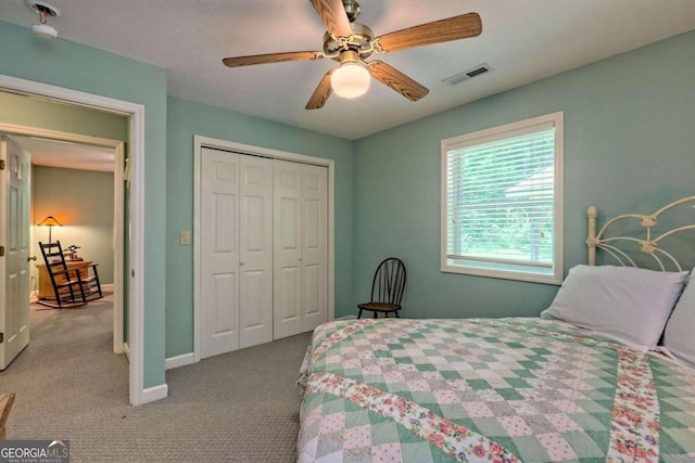 carpeted bedroom with a closet and ceiling fan