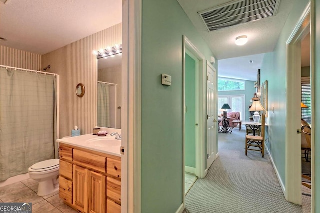 bathroom with tile patterned floors, a shower with curtain, vanity, vaulted ceiling, and toilet