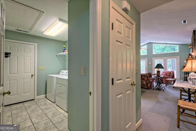 interior space with washer and dryer, light colored carpet, and french doors