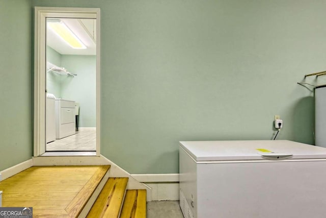 clothes washing area with washing machine and dryer