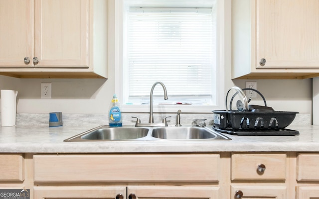 kitchen featuring light brown cabinets and sink