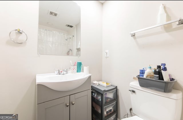 bathroom with vanity and toilet