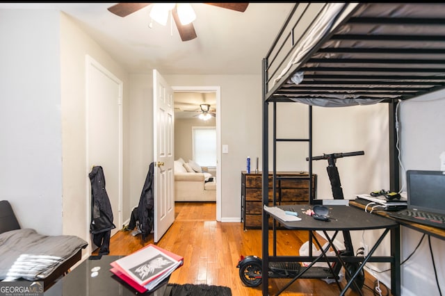 bedroom with light hardwood / wood-style flooring and ceiling fan