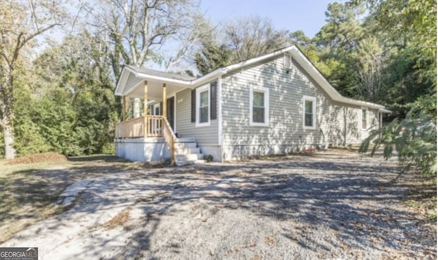 view of property exterior with covered porch