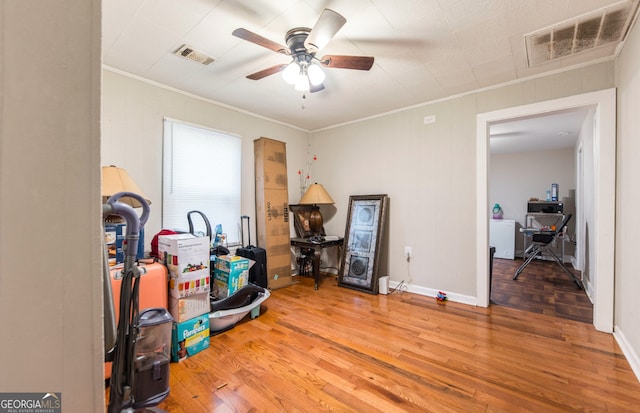 misc room featuring hardwood / wood-style floors, ceiling fan, and crown molding