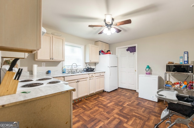 kitchen with dark parquet floors, ceiling fan, sink, white fridge, and fridge