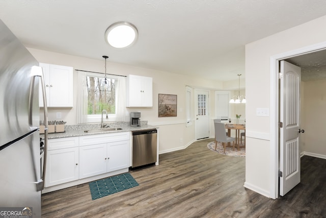 kitchen with stainless steel appliances, a chandelier, and white cabinets