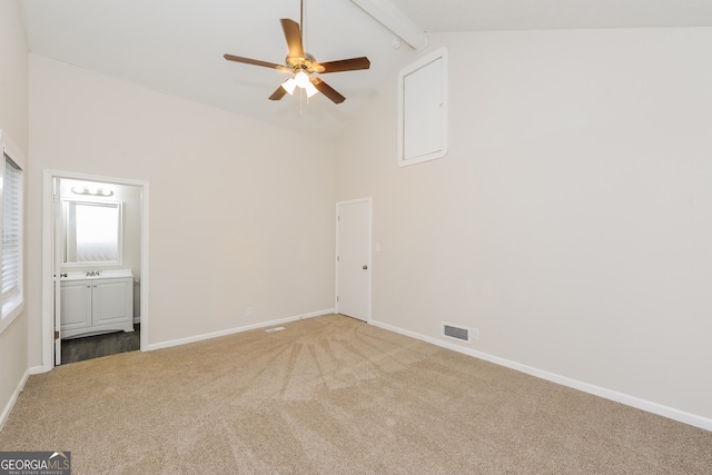 carpeted empty room with high vaulted ceiling, beam ceiling, and ceiling fan