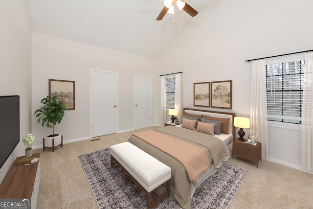 bedroom featuring high vaulted ceiling, light carpet, and ceiling fan