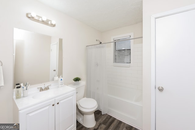 full bathroom featuring toilet, tiled shower / bath, vanity, hardwood / wood-style flooring, and a textured ceiling