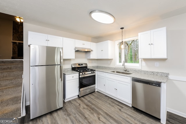 kitchen with sink, hardwood / wood-style floors, white cabinets, and stainless steel appliances