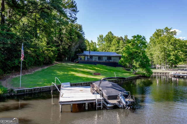 dock area featuring a lawn and a water view