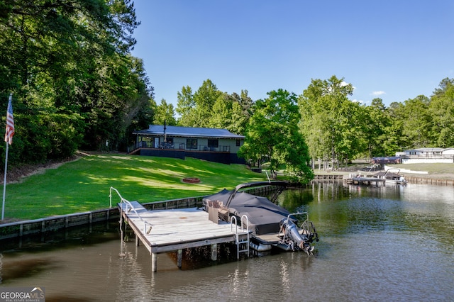 view of dock featuring a lawn and a water view