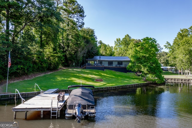 dock area featuring a lawn and a water view