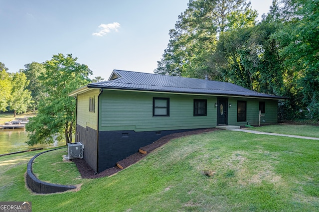 ranch-style house featuring central AC unit and a front yard