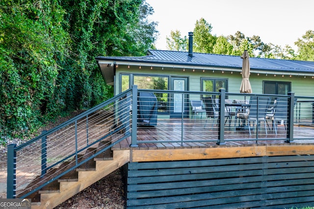 back of property featuring a wooden deck