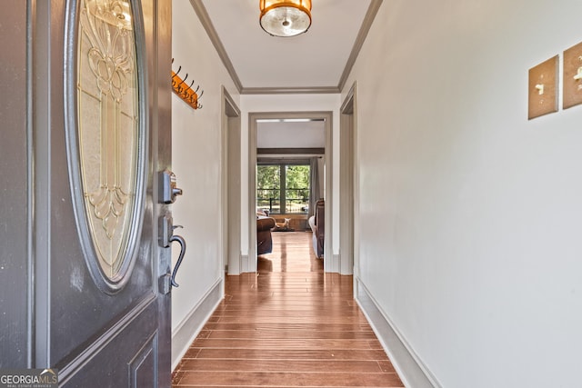 interior space with hardwood / wood-style floors and ornamental molding