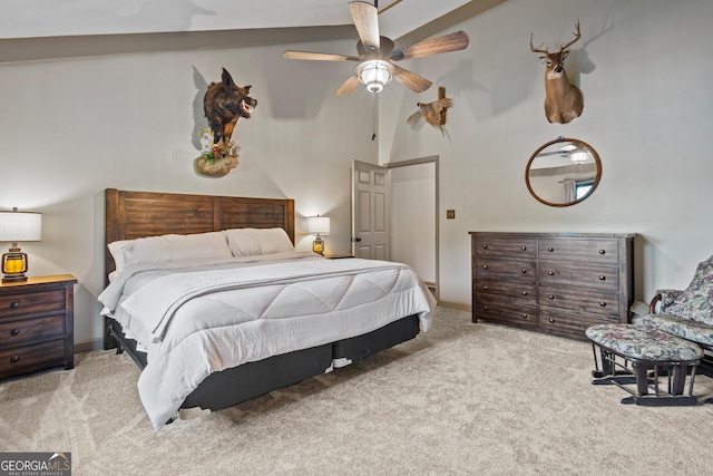 carpeted bedroom with high vaulted ceiling and ceiling fan