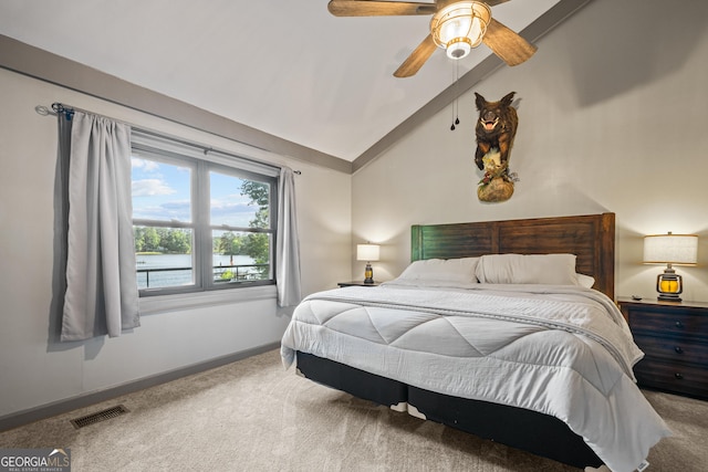 bedroom with ceiling fan, carpet floors, and lofted ceiling