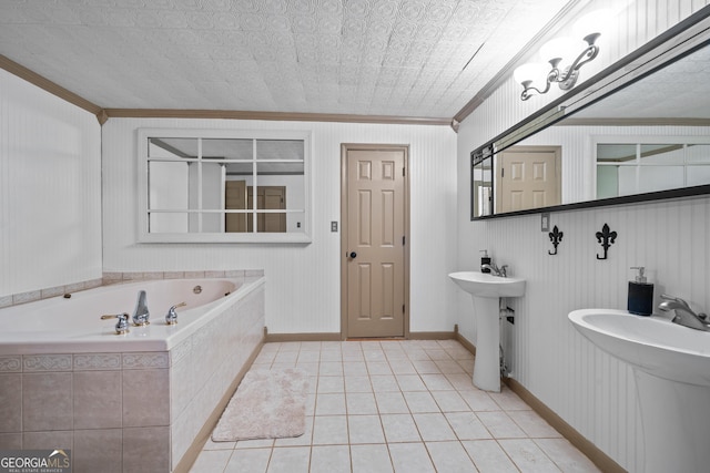 bathroom featuring tile patterned floors, tiled tub, sink, and ornamental molding