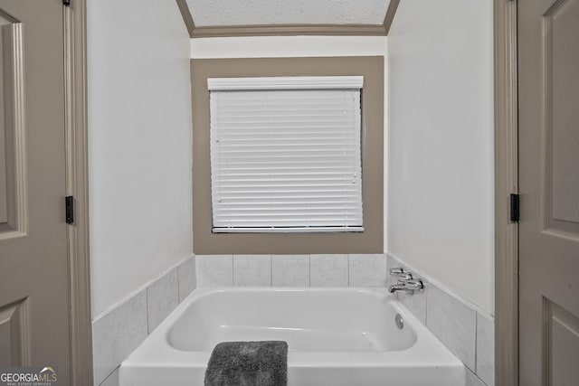 bathroom with a textured ceiling and a bathing tub