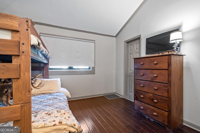 bedroom featuring crown molding, dark hardwood / wood-style flooring, and lofted ceiling