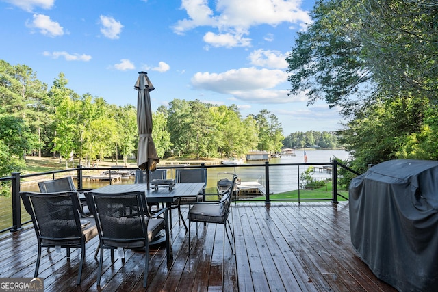 wooden deck with a grill and a water view