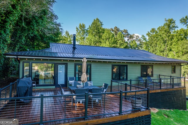 rear view of house featuring a deck