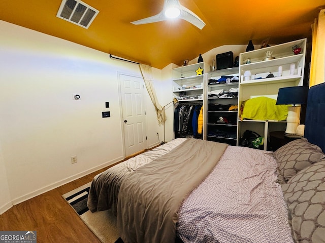 bedroom with wood-type flooring, vaulted ceiling, and ceiling fan