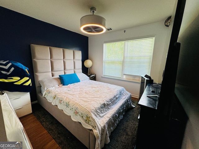 bedroom with dark hardwood / wood-style flooring