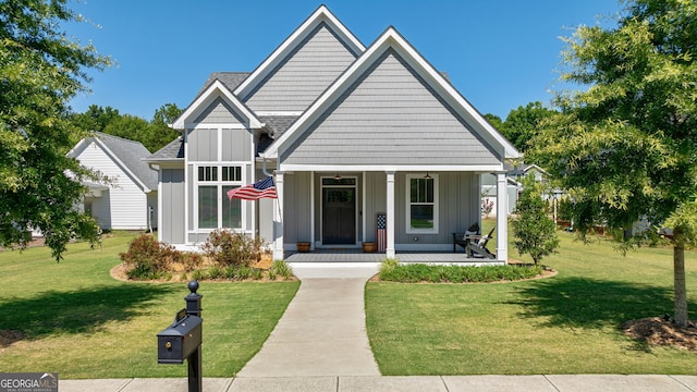 view of front of home with covered porch and a front lawn