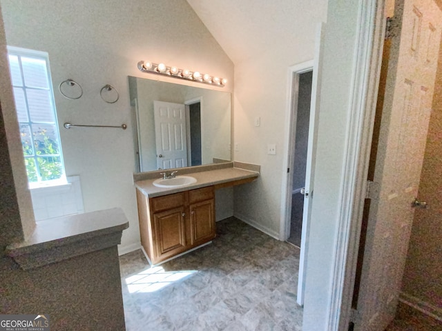 bathroom with vanity and vaulted ceiling